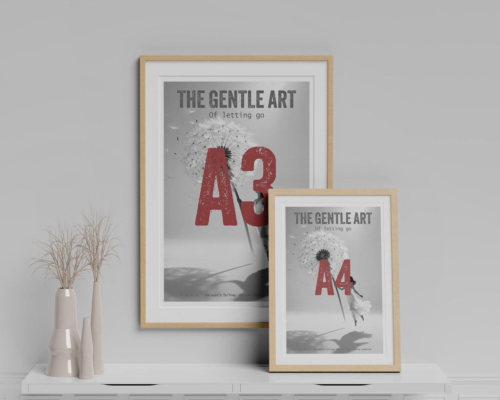 Two framed prints on a shelf with decorative vases against a gray wall.