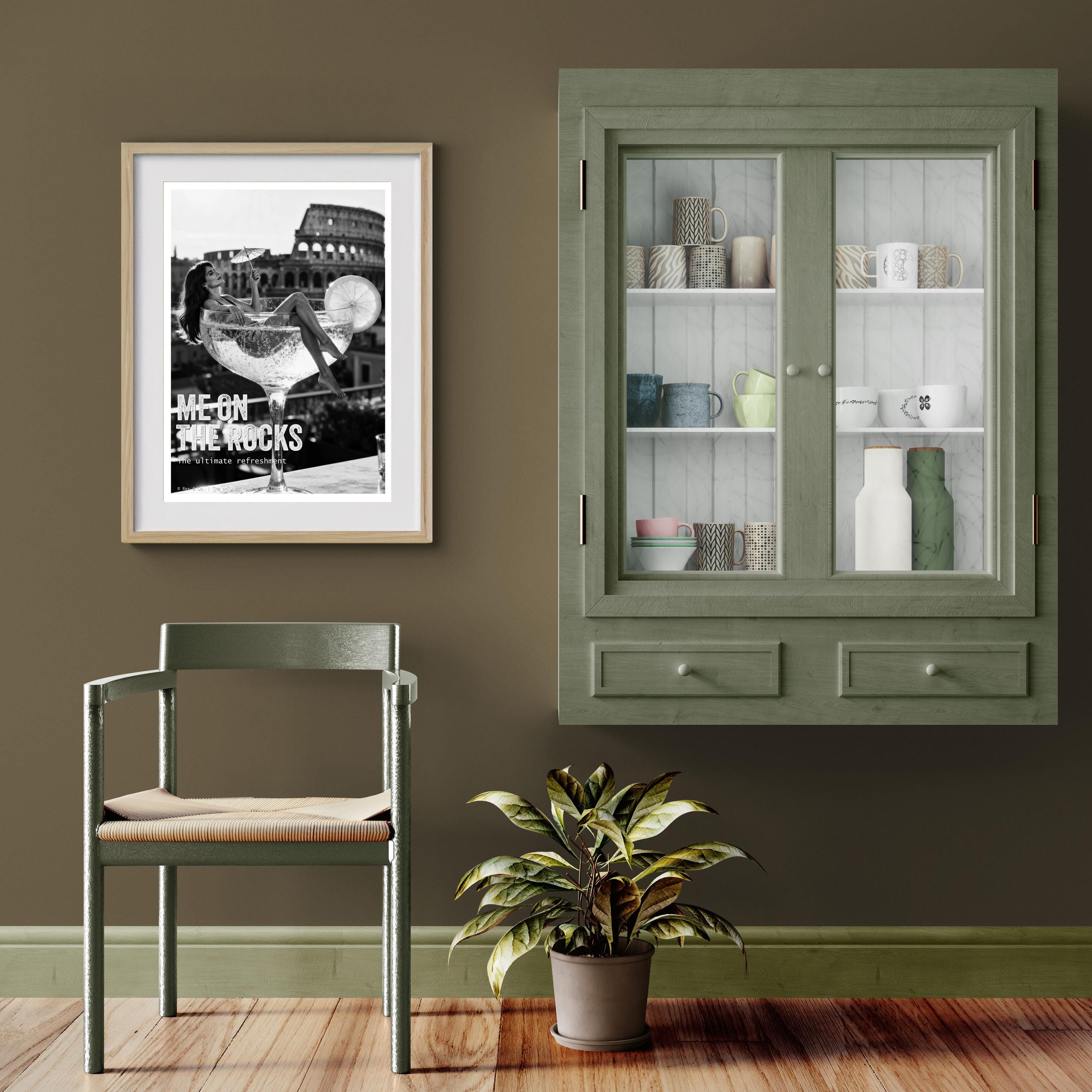 Green cabinet with glass doors, chair, plant, and framed picture on a brown wall.