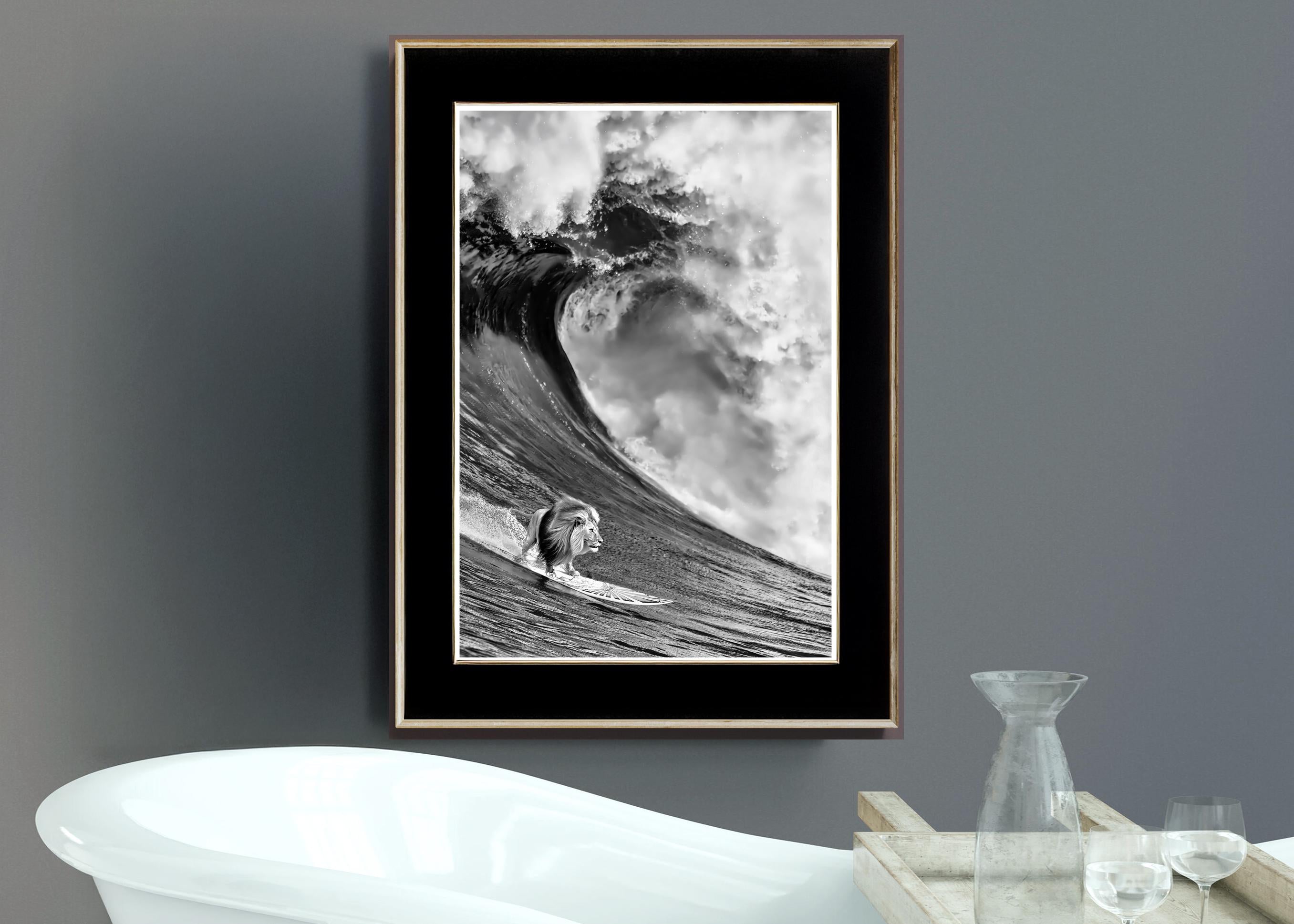 Framed black and white artwork of a lion surfer on a wave above a bathtub.