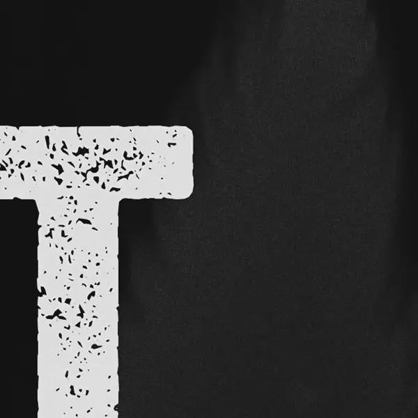 Close-up of a white letter 'T' on a black background