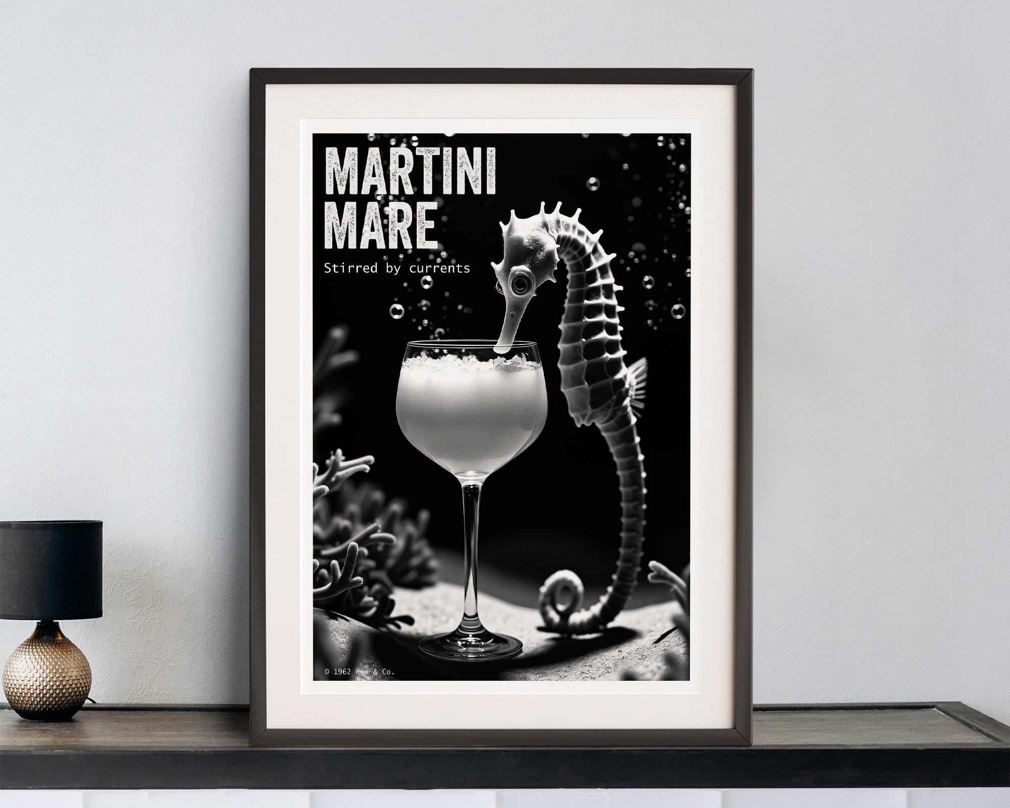Framed artwork of a seahorse with a Martini cocktail on a shelf.