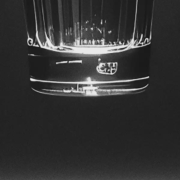 Close-up of a whiskey glass on a black background