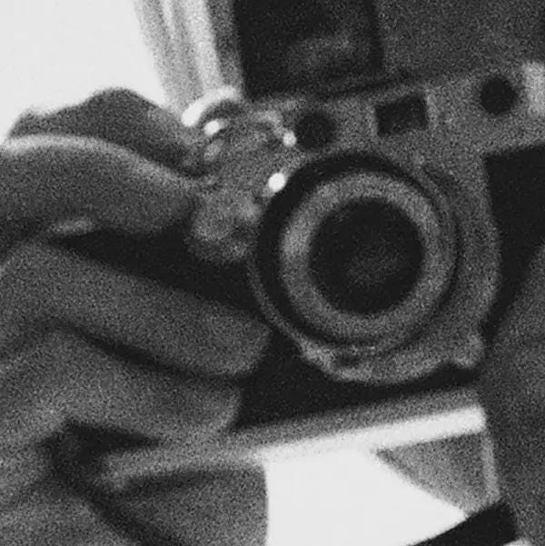 Close-up of a vintage camera held by Audrey Hepburn.