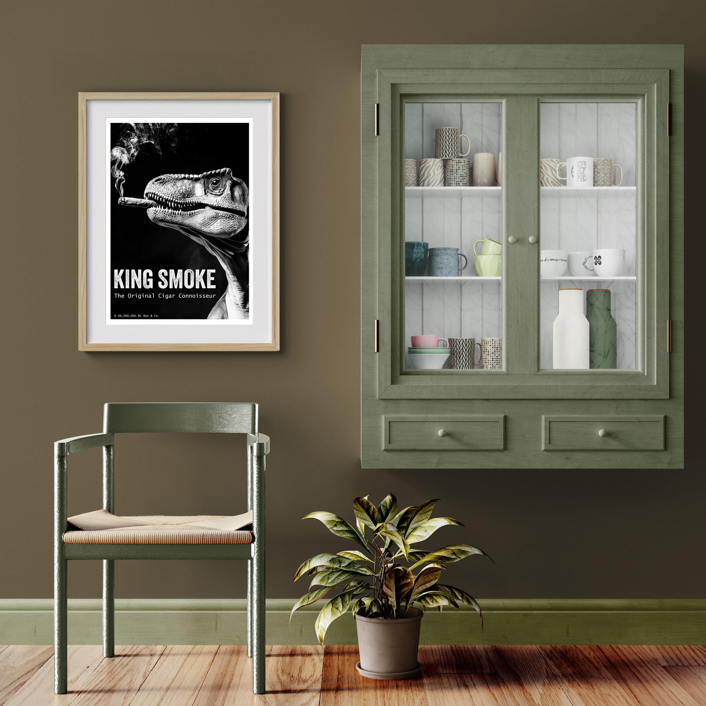 Room interior with a framed poster, chair, plant, and cabinet.