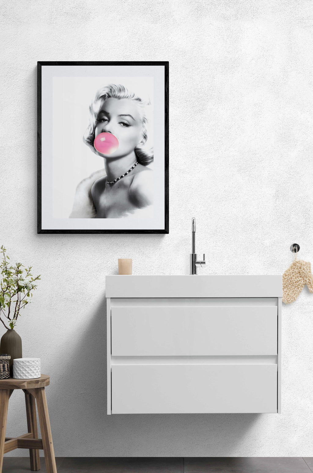 Bathroom with a framed portrait of Marilyn Monroe on the wall above a sink.