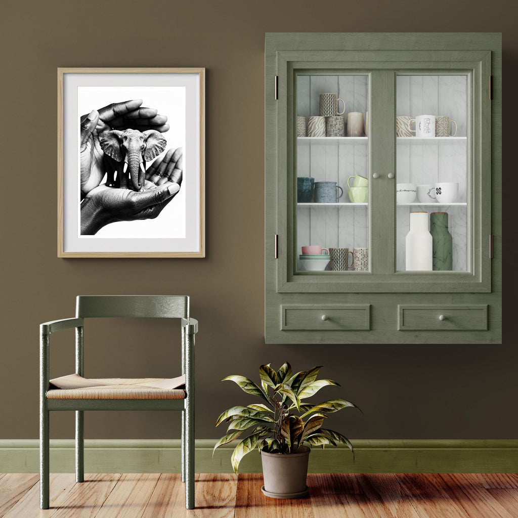 Room interior with a green cabinet, chair, and framed picture on a brown wall.