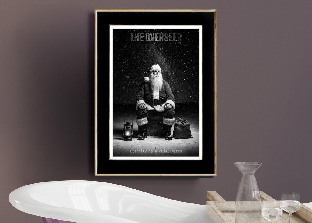 Framed poster of Santa 'The Overseer' on a wall with a modern interior setting.