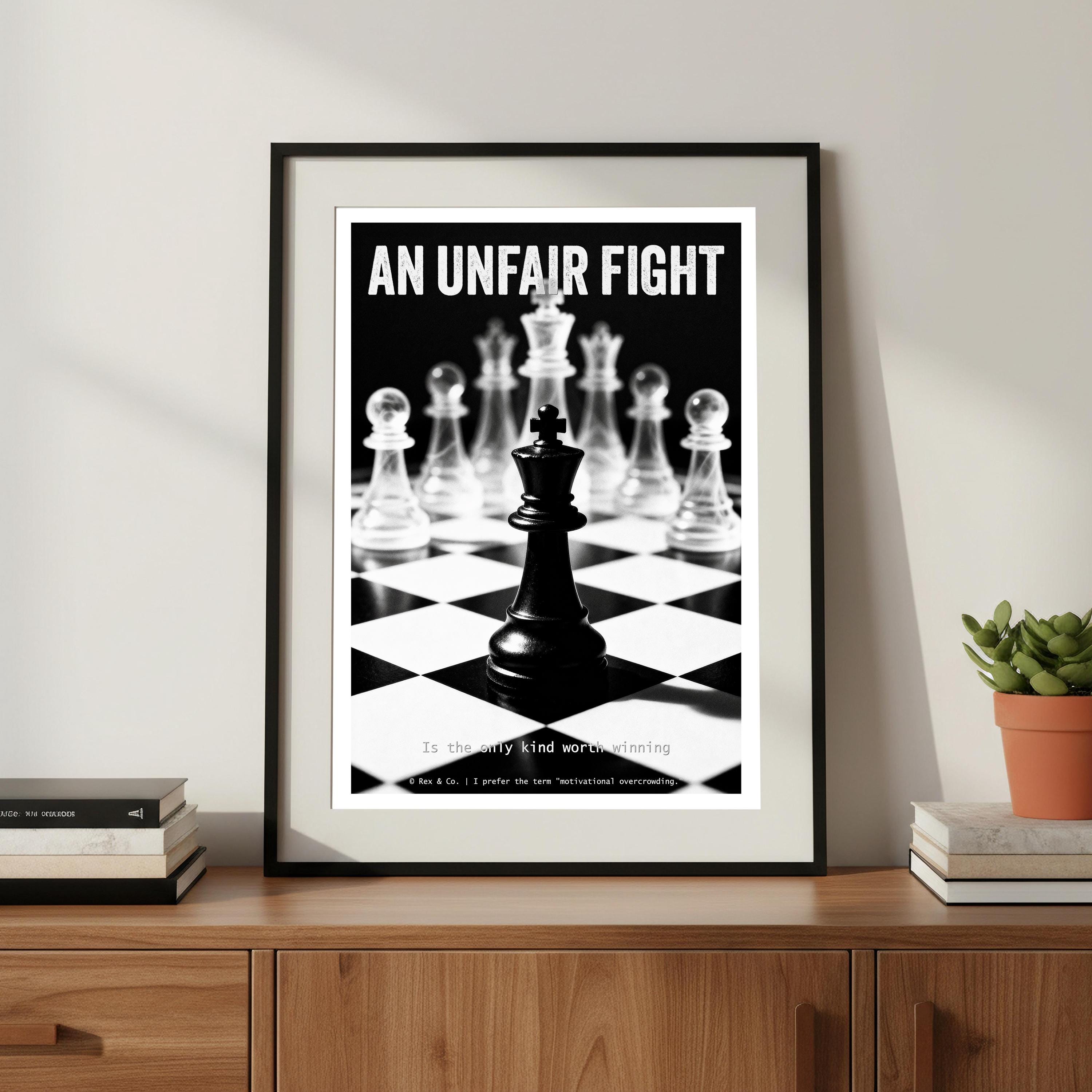 Framed poster titled 'An Unfair Fight' with chess pieces on a checkered background, displayed on a wooden surface.
