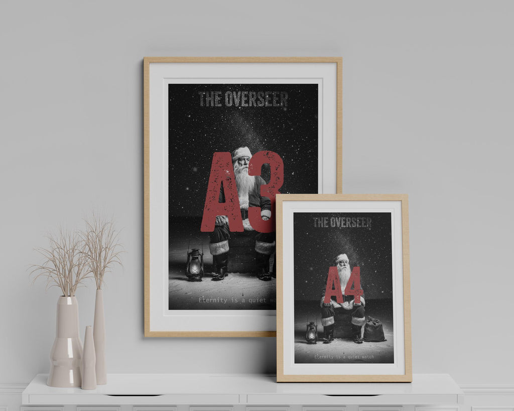 Two framed posters of Santa with 'The Overseen' text on a gray wall.