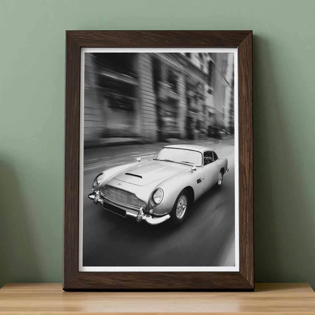 Framed black and white print of a classic car on a city street.