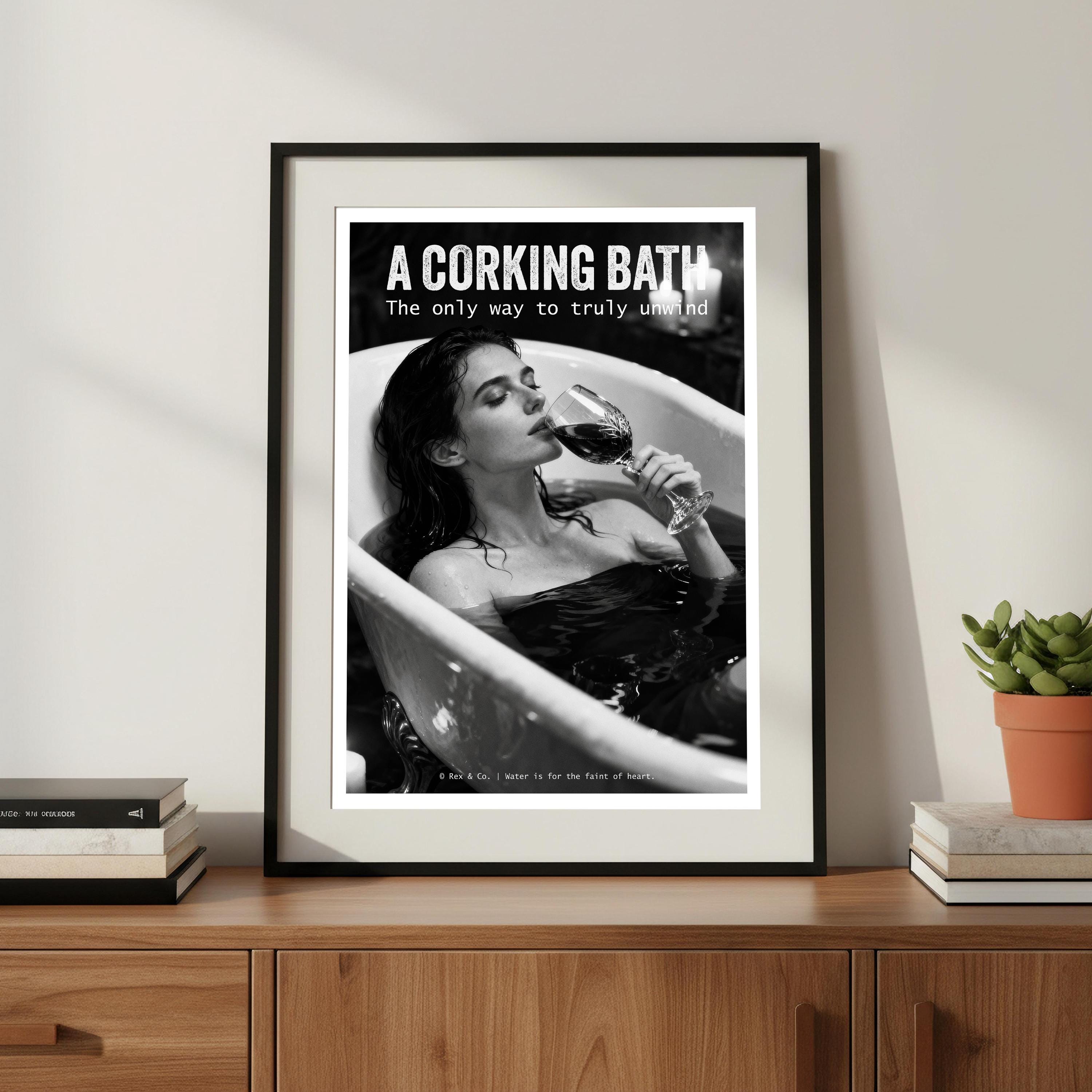 Framed poster of a woman in a bath with a glass of wine, text 'A Corking Bath' on a wooden shelf.