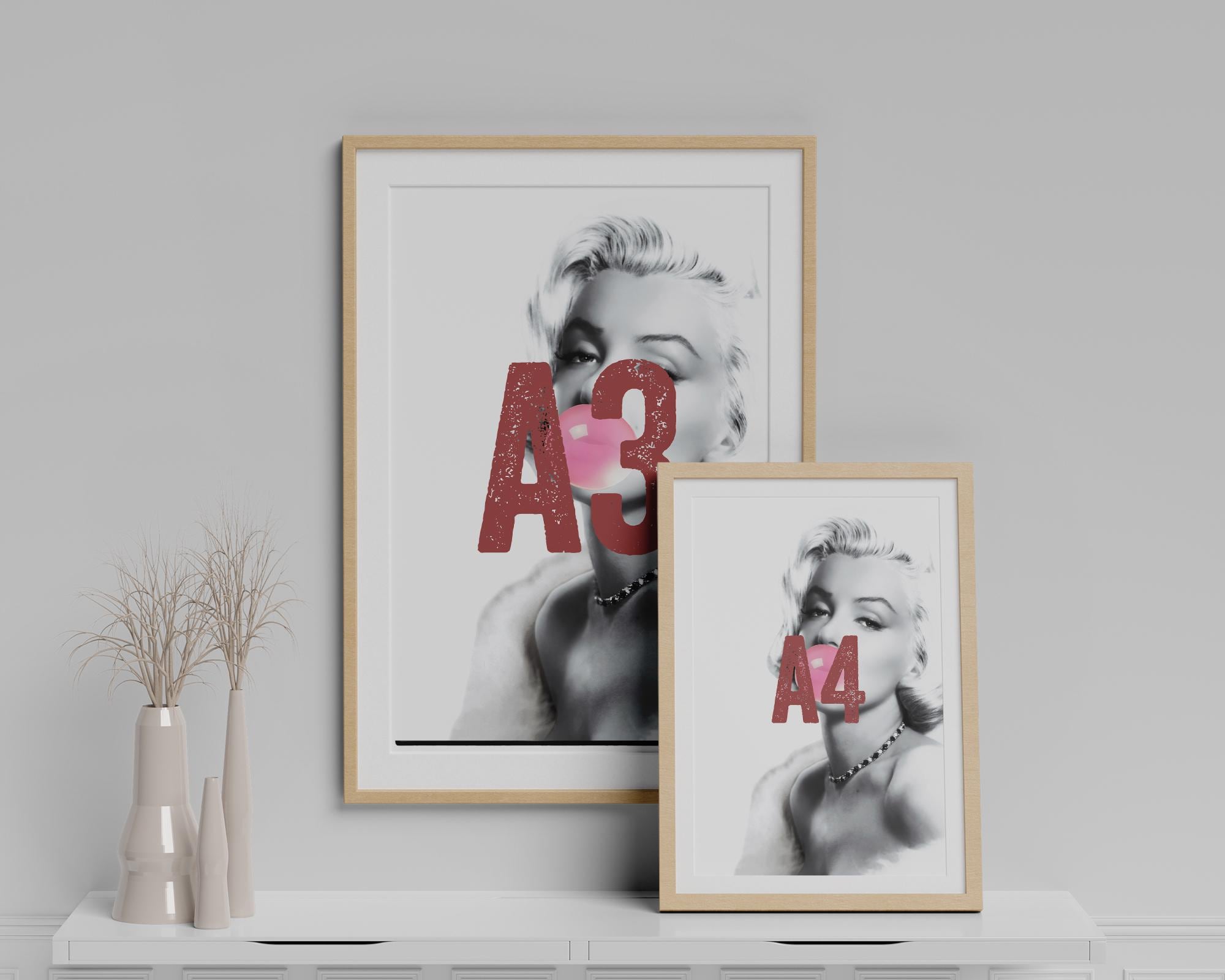 Two framed prints of a stylized portrait of Marilyn Monroe with 'A3' and 'A4' text on a white surface.