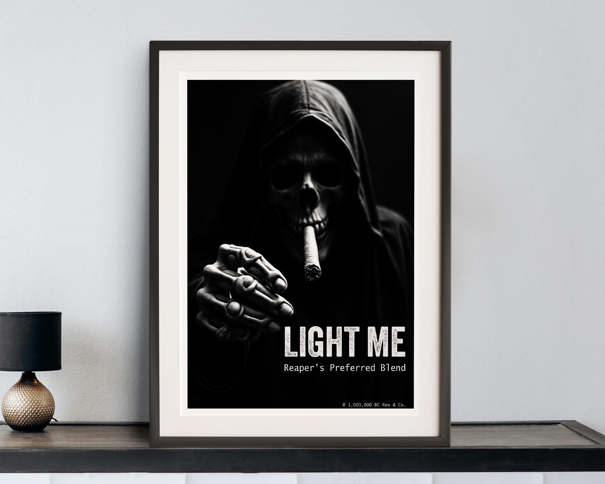 Framed poster of a hooded grim reaper smoking with 'Light Me' text on a wall.