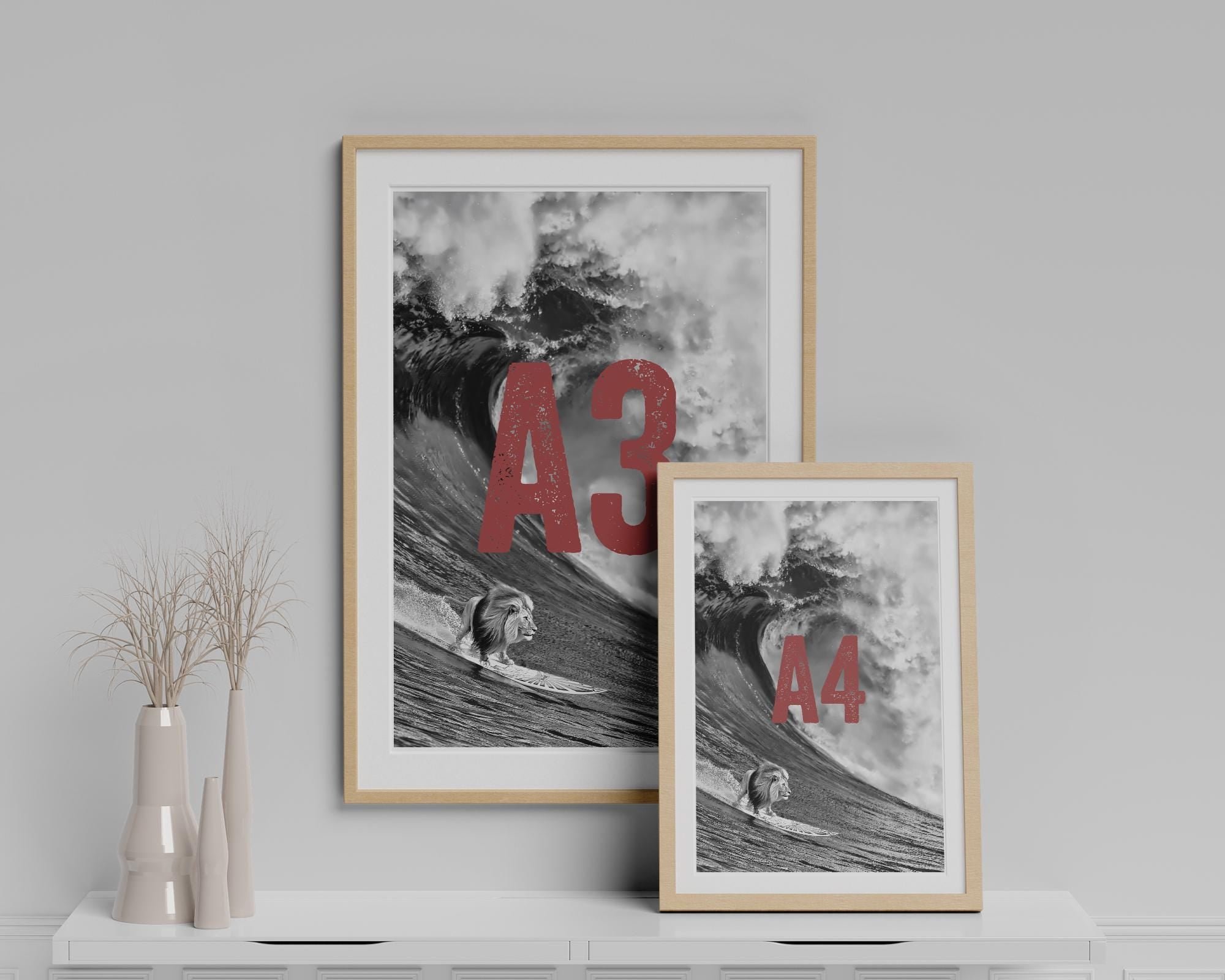 Two framed prints on a shelf with 'A3' and 'A4' text, against a gray wall.