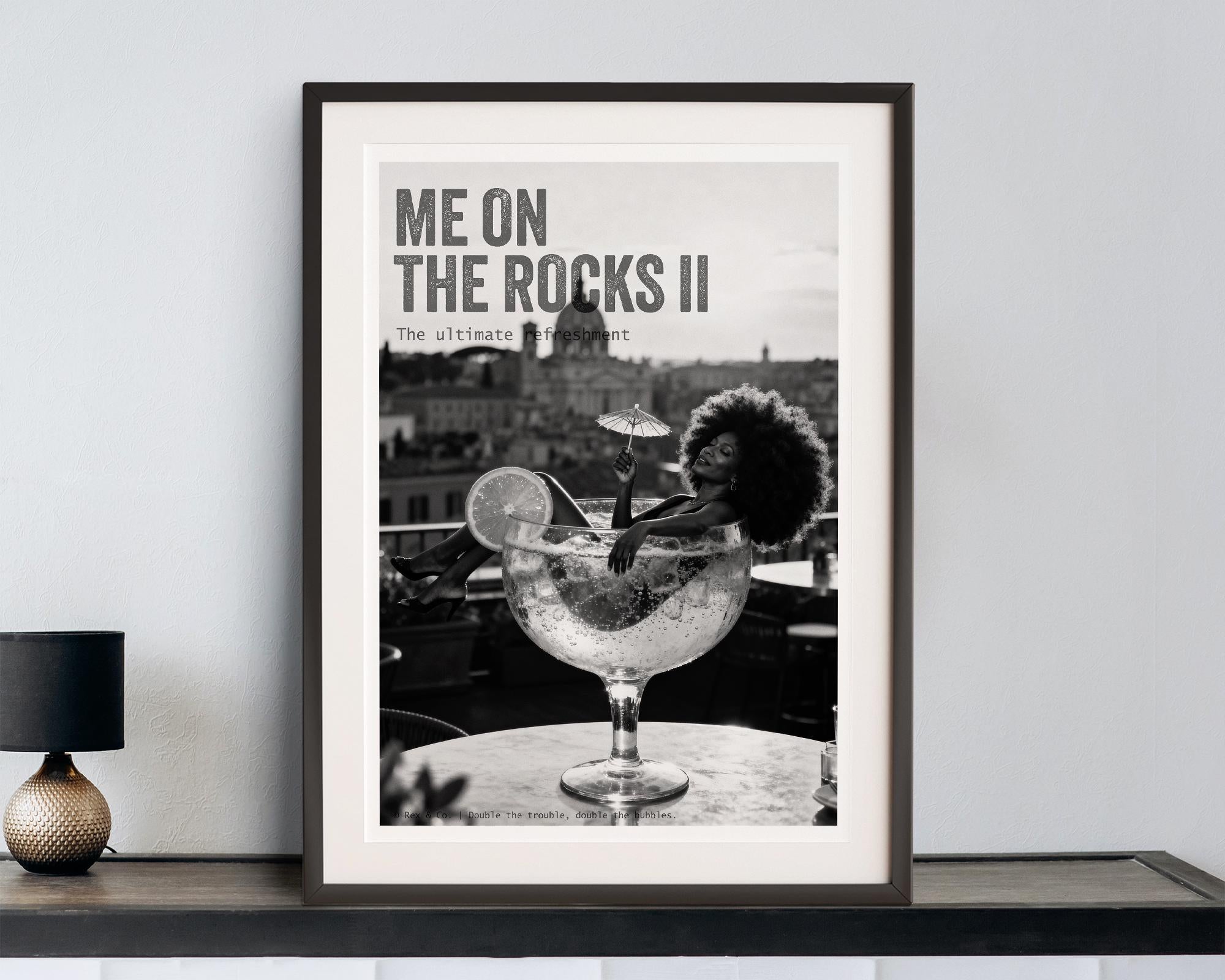 Framed poster with a cocktail image and text 'Me on the Rocks II' on a wall.